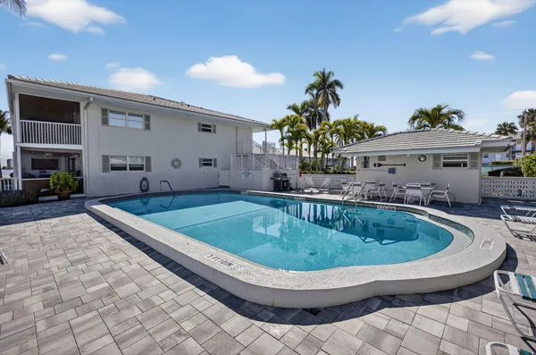 a view of a patio with a table and chairs
