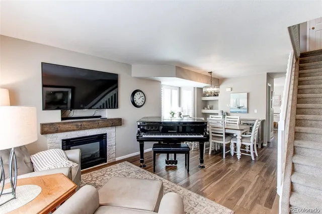 a living room with furniture a fireplace and flat screen tv