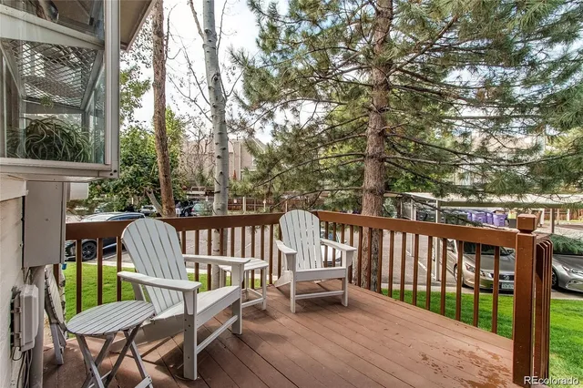 a view of a deck with a floor to ceiling window and wooden fence