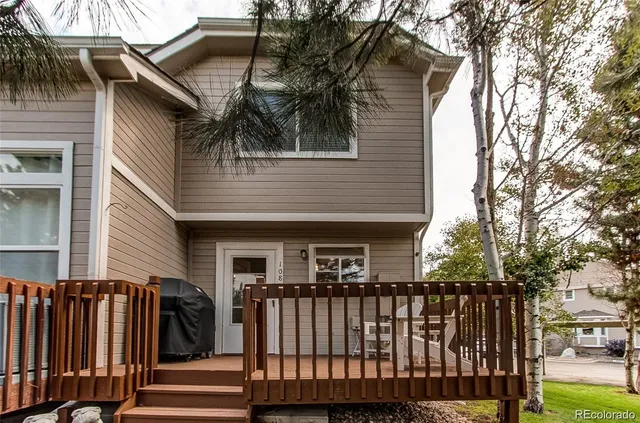 a view of a two chairs and table in the back