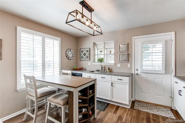 a kitchen with a stove a cabinets and a window