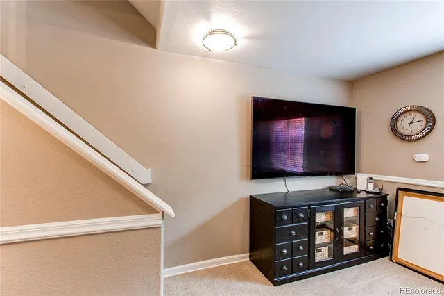 a living room with furniture a rug and a window