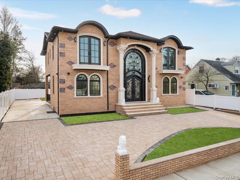 French country home with brick siding