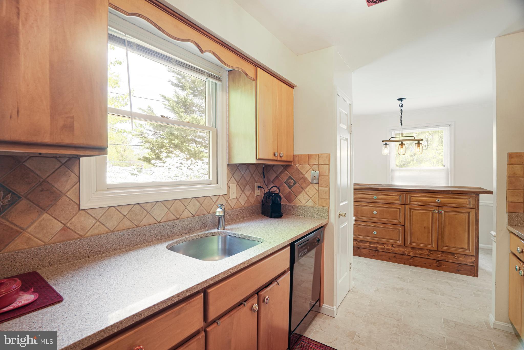 8872 Woodland Drive Silver Spring, MD 20910 - Photo 12 of 47 a kitchen with a sink cabinets appliances and a window