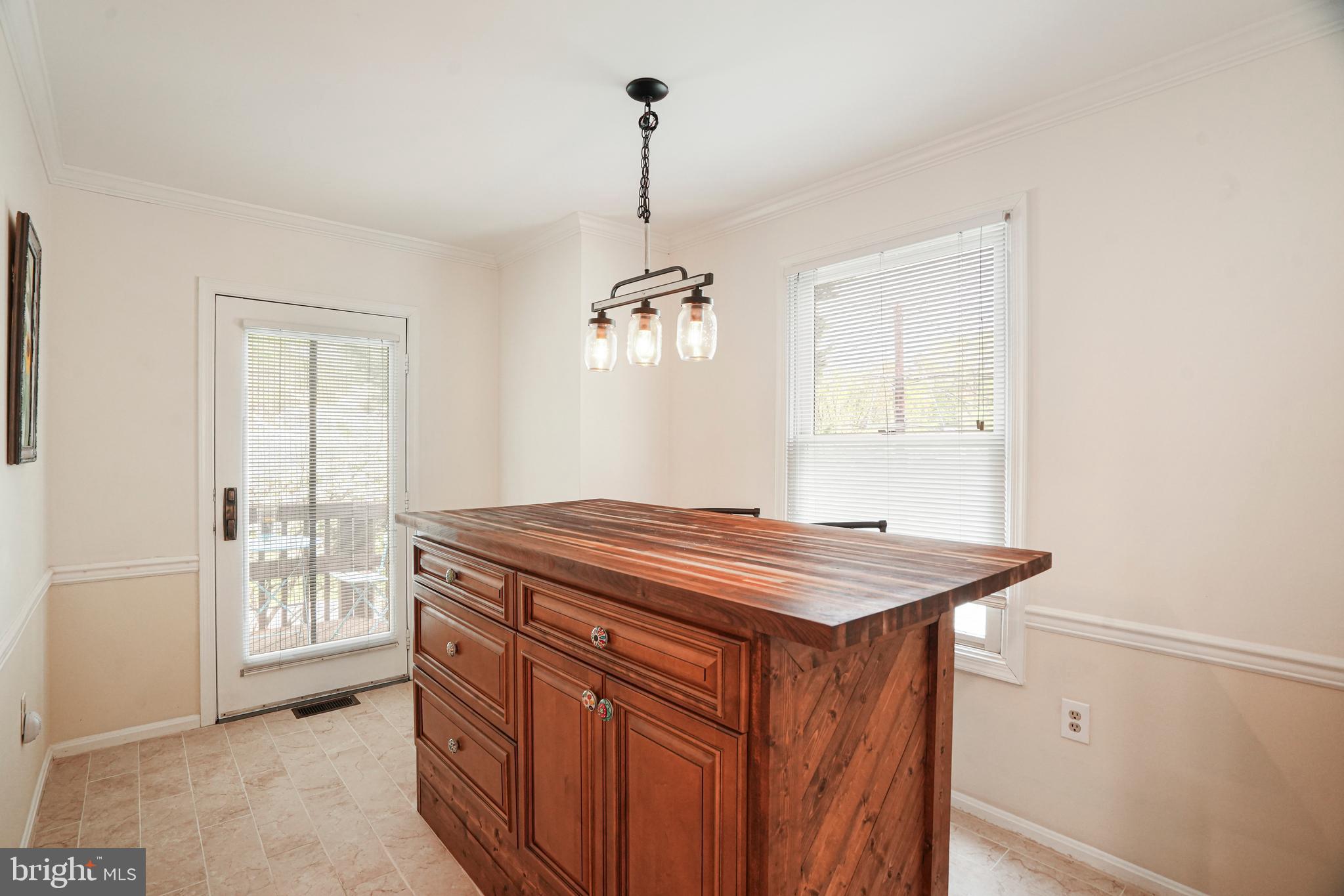 8872 Woodland Drive Silver Spring, MD 20910 - Photo 13 of 47 a room that has a bed and a chandelier