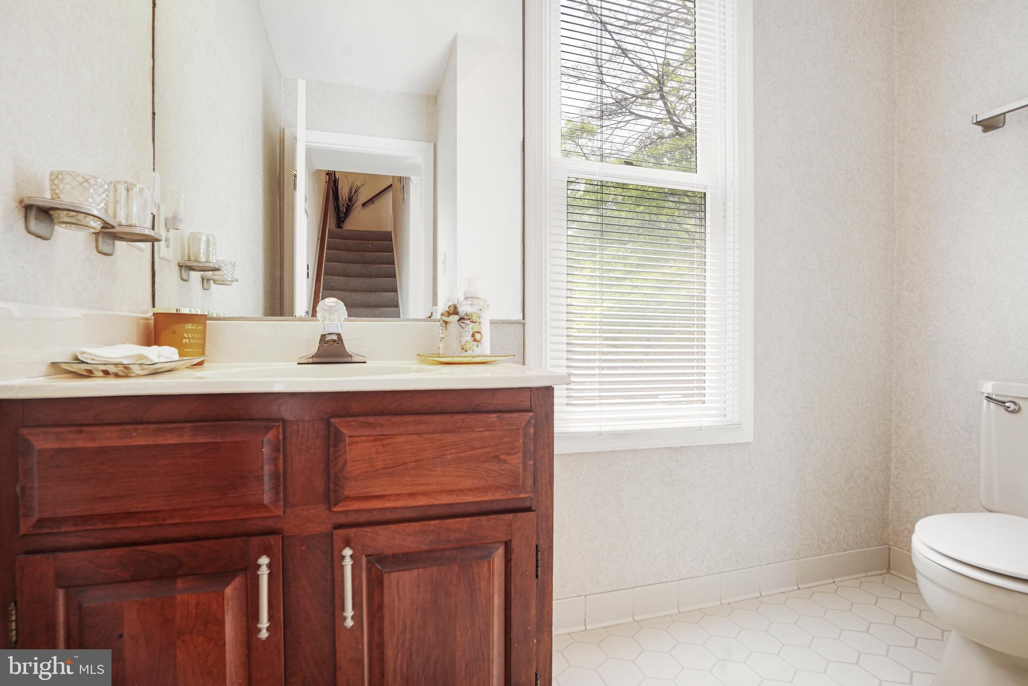 8872 Woodland Drive Silver Spring, MD 20910 - Photo 15 of 47 a bathroom with a sink a toilet and a window