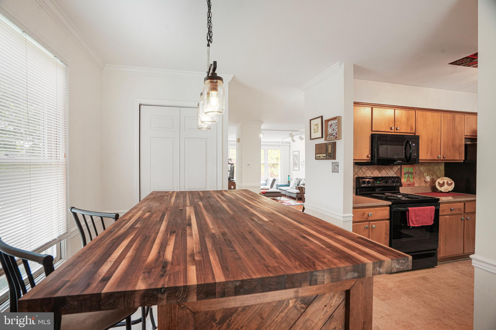 8872 Woodland Drive Silver Spring, MD 20910 - Photo 8 of 47 a bed sitting in a spacious bedroom and a flat screen tv