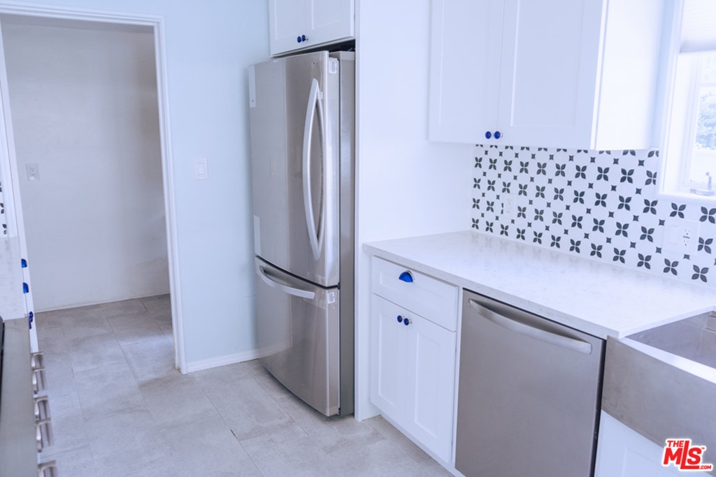 5478 Village Los Angeles, CA 90016 - Photo 11 of 31 a view of kitchen cabinets and refrigerator