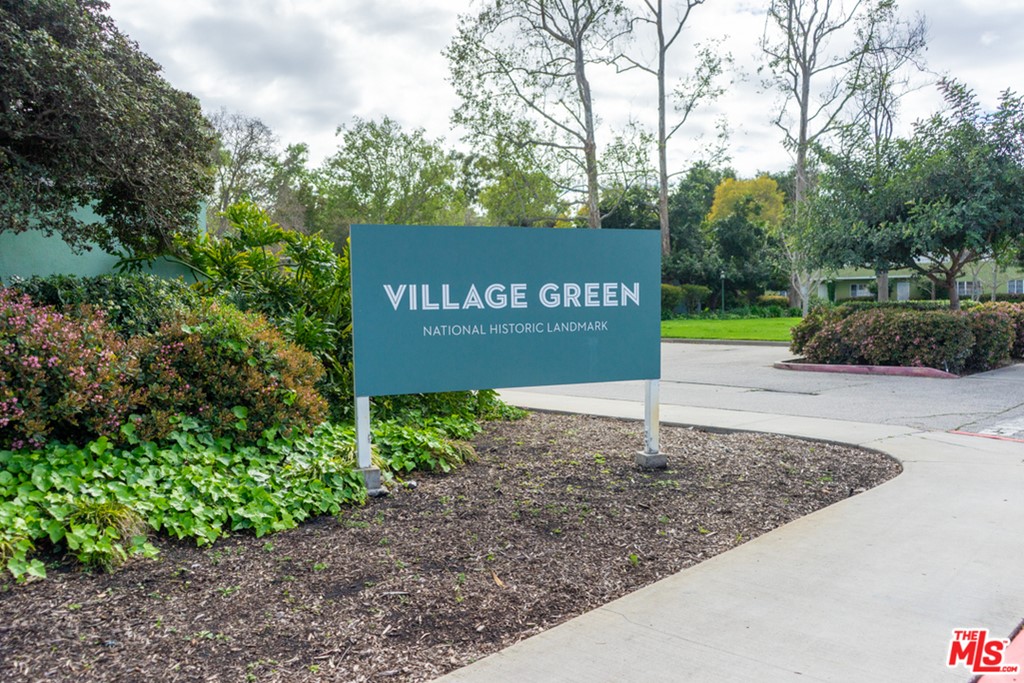 5478 Village Los Angeles, CA 90016 - Photo 2 of 31 a sign that is sitting on a brick wall