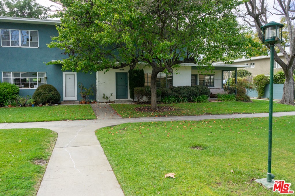 5478 Village Los Angeles, CA 90016 - Photo 28 of 31 a front view of a house with yard and green space