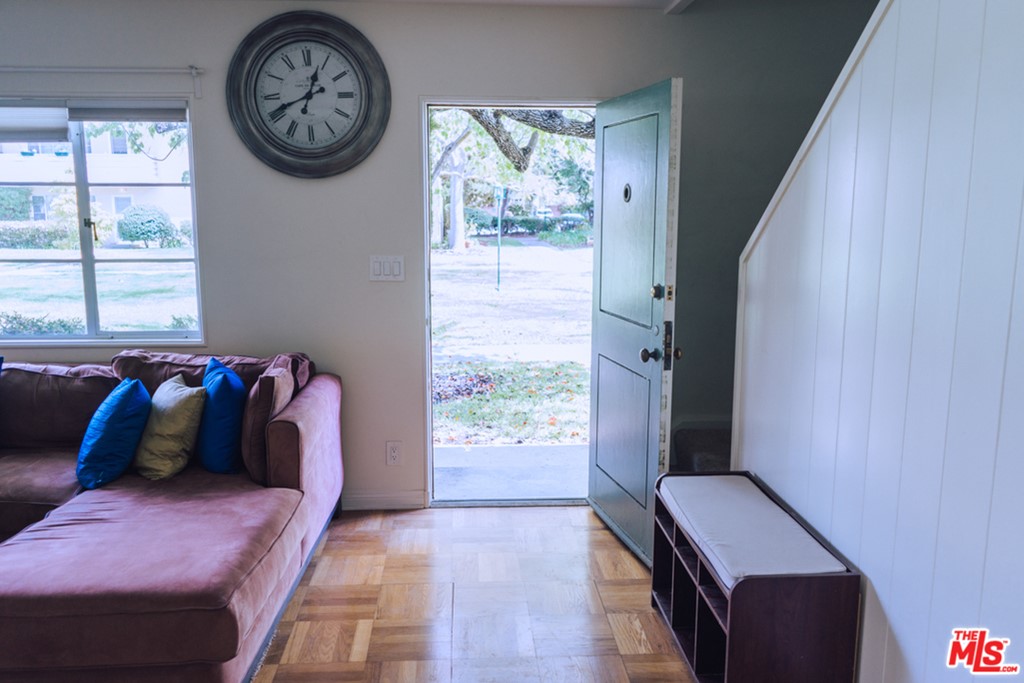 5478 Village Los Angeles, CA 90016 - Photo 3 of 31 a bedroom with a bed a clock on the dresser and a window