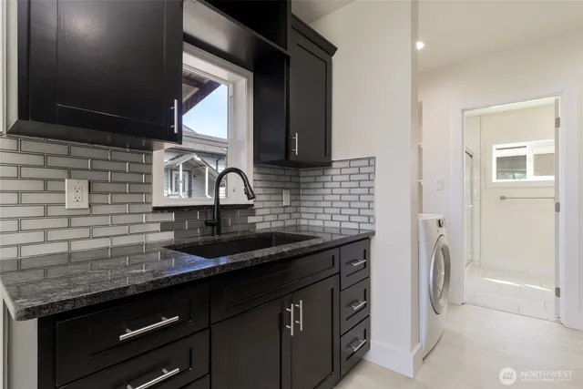 a kitchen with stainless steel appliances granite countertop a sink stove and cabinets