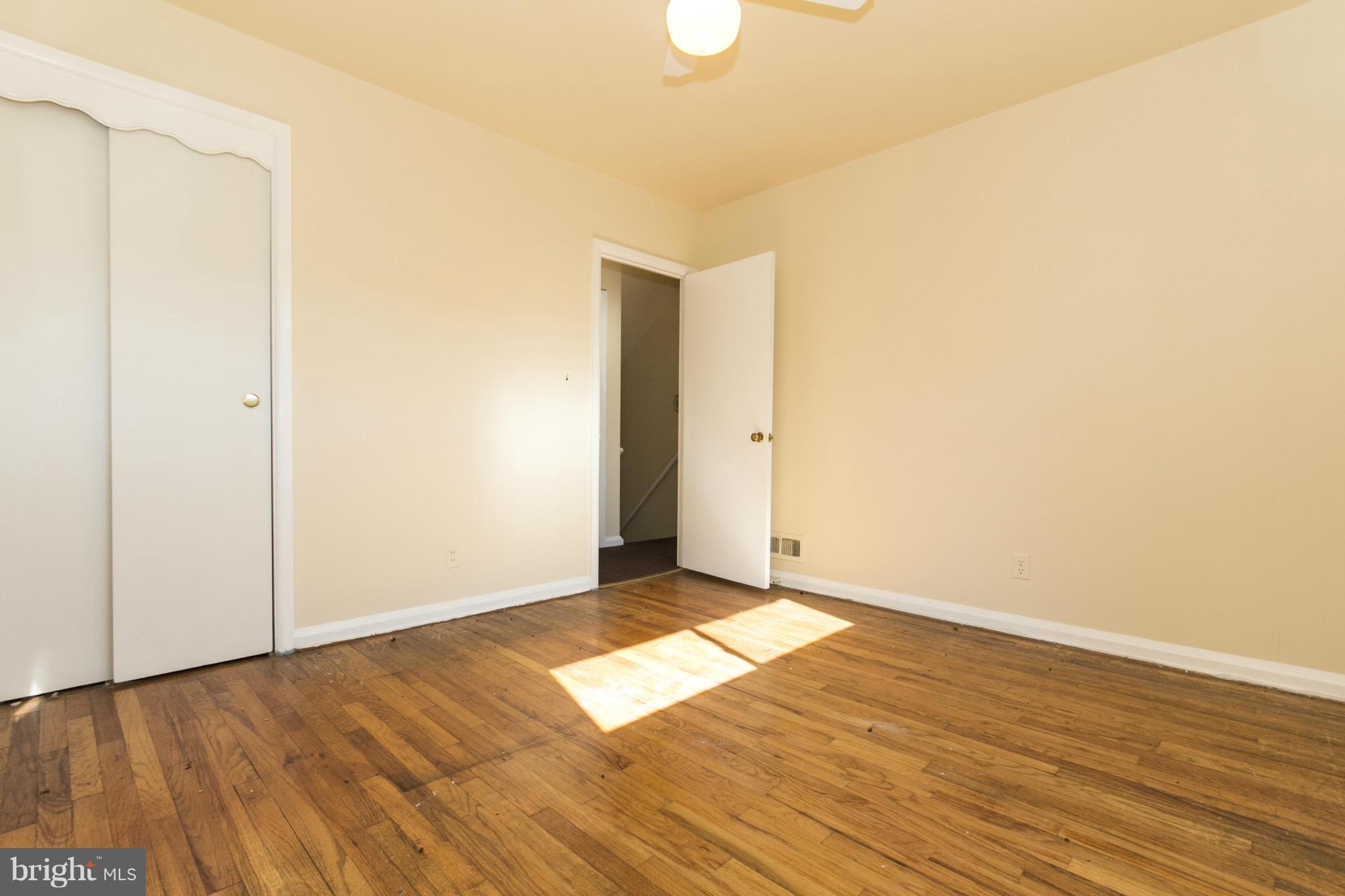 7105 Boxford Road Baltimore, MD 21215 - Photo 22 of 27 a view of an empty room with wooden floor