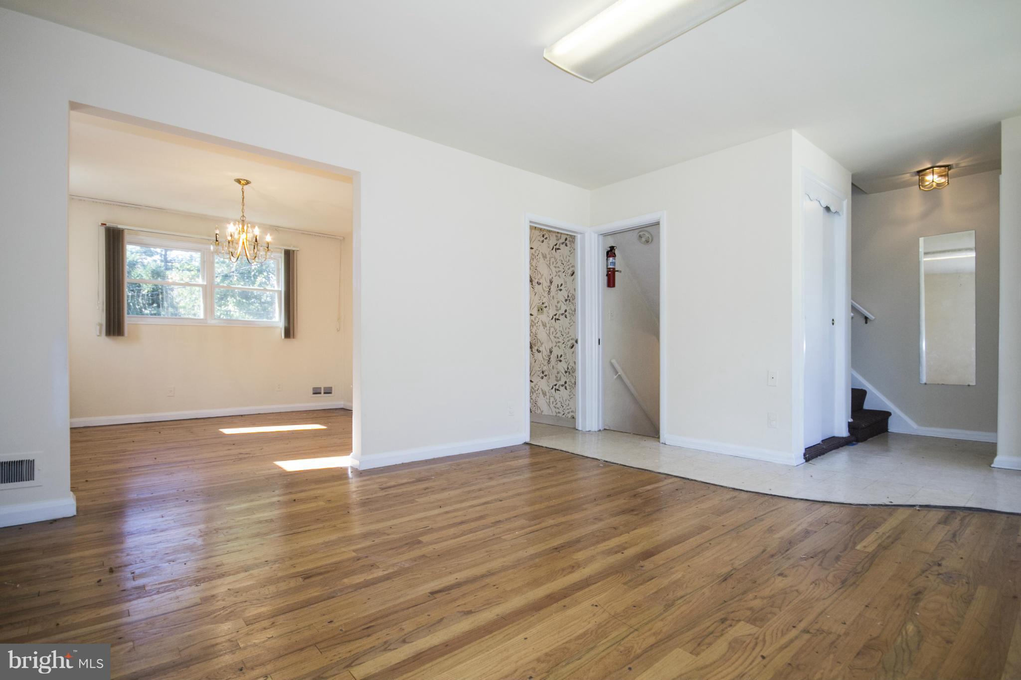 7105 Boxford Road Baltimore, MD 21215 - Photo 5 of 27 an empty room with wooden floor and windows