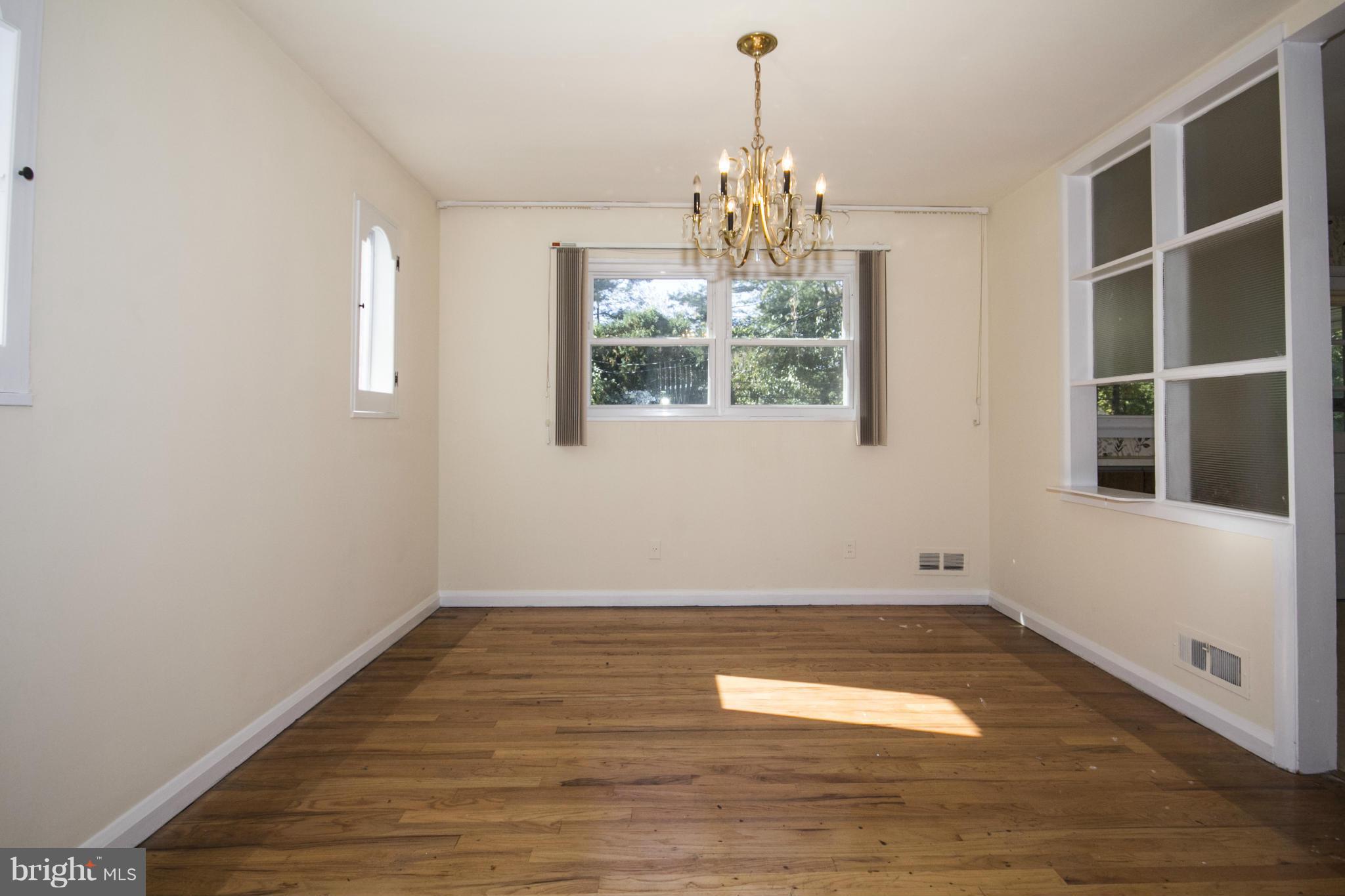 7105 Boxford Road Baltimore, MD 21215 - Photo 8 of 27 a view of empty room with wooden floor and fan