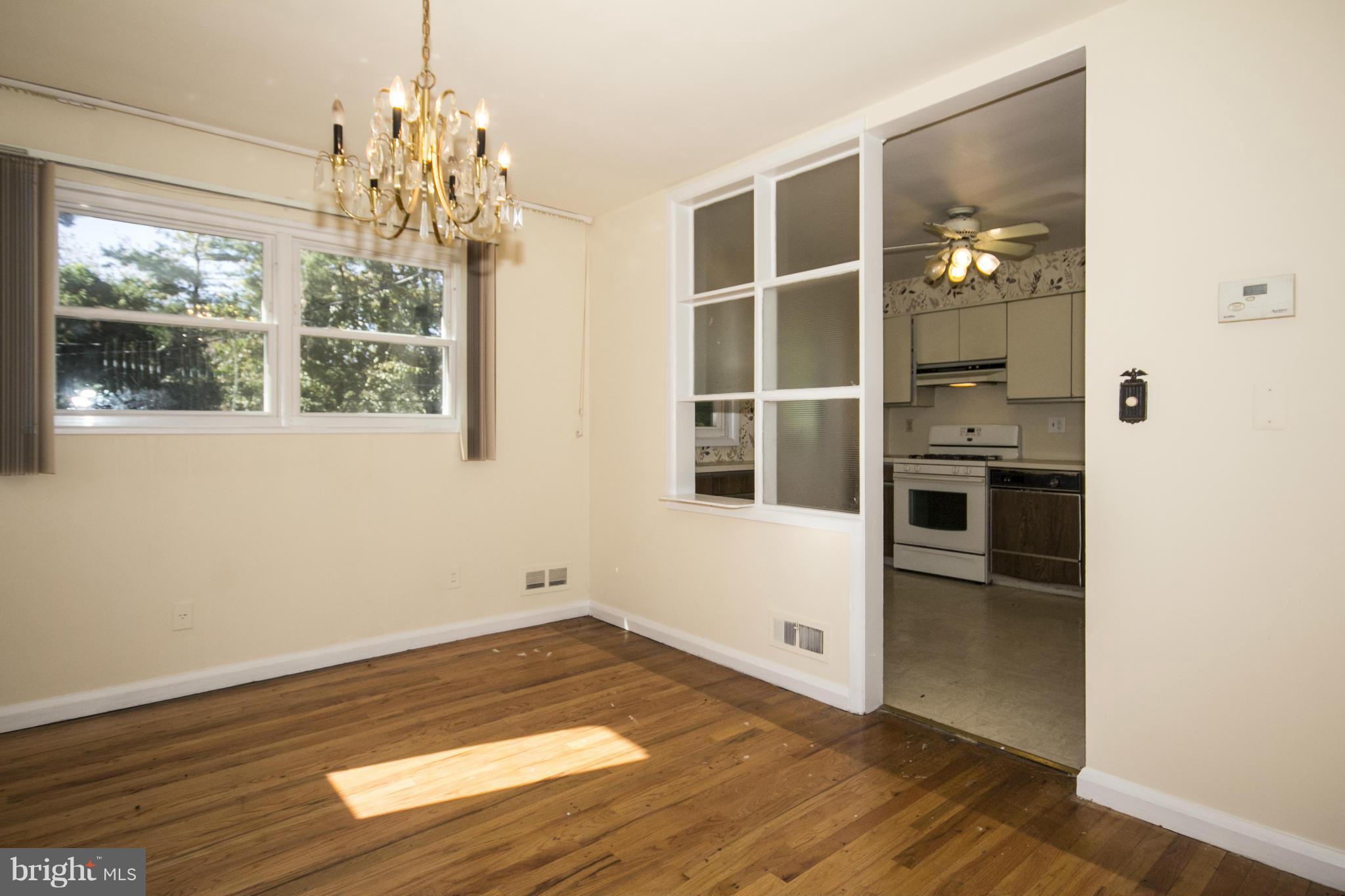 7105 Boxford Road Baltimore, MD 21215 - Photo 9 of 27 wooden floor in an empty room with a window