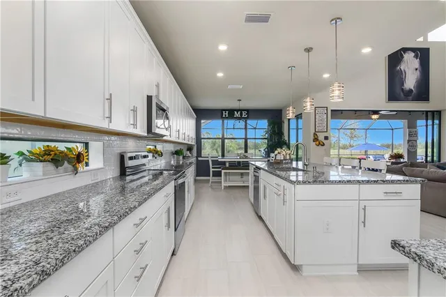 a kitchen with stainless steel appliances granite countertop lots of counter top space and cabinets