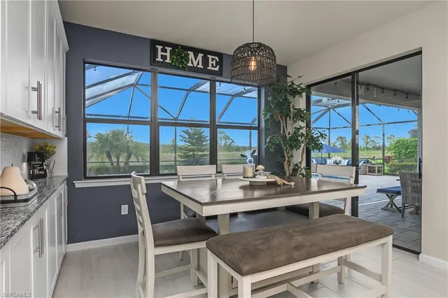 a dining table painted next to a large window with table and chairs