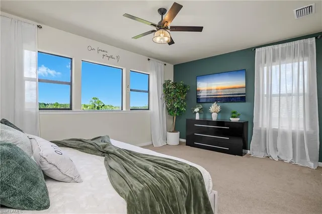 a bedroom with a bed and a flat tv screen