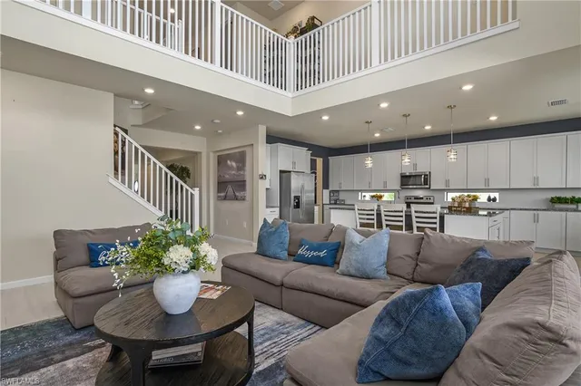 a living room with furniture and a kitchen view