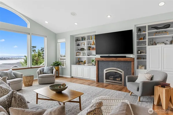 a living room with furniture a fireplace and a flat screen tv