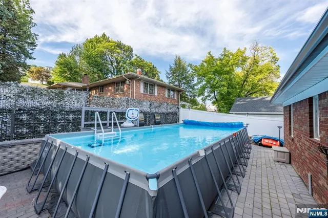 a view of a roof deck with table and chairs and potted plants