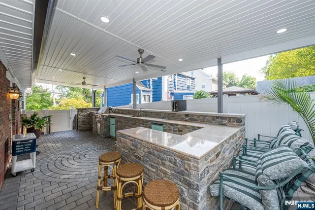a kitchen with furniture and a large window