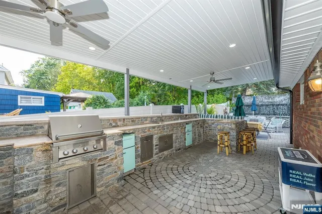 a open kitchen with stainless steel appliances granite countertop a sink and cabinets