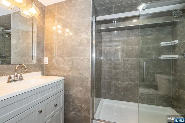 a bathroom with a shower and a sink