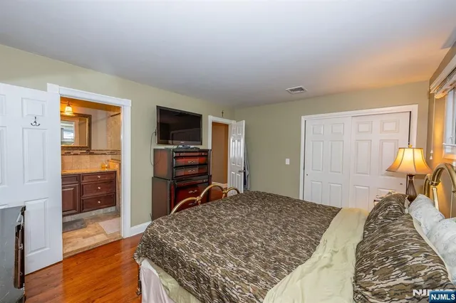 a bedroom with a bed and a television