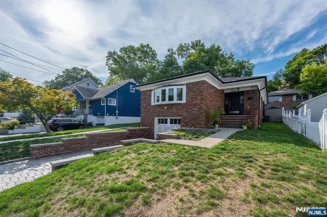 a house view with a sitting space and garden