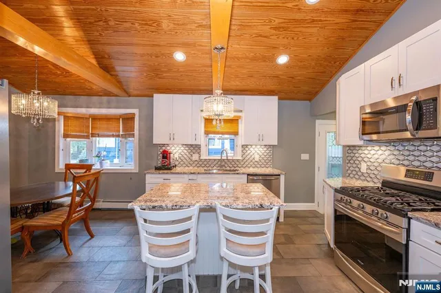 a kitchen with a stove a sink and a refrigerator
