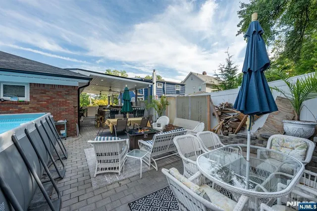 an outdoor space with patio the couches and a dining table with the garden view