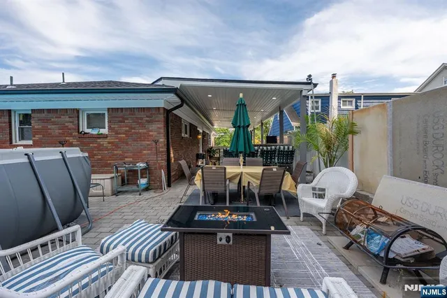 a view of a patio with couches chairs and wooden floor