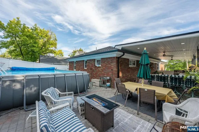 a view of a patio with couches table and chairs and potted plants