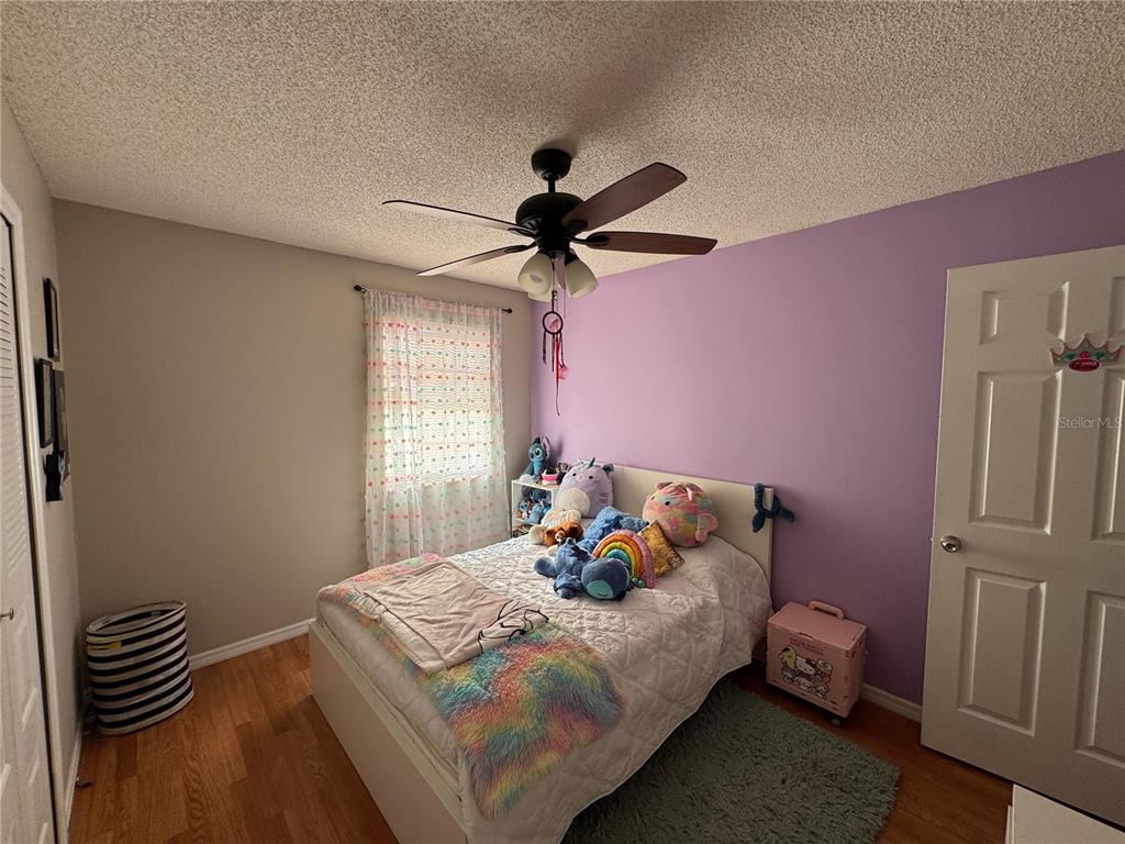 655 Magic Court, Unit 188 Altamonte Springs, FL 32714 - Photo 14 of 33 a bedroom with a bed and a chandelier