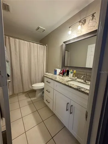 a kitchen with sink a microwave and cabinets