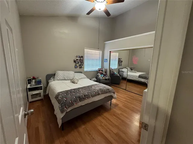 a bedroom with a bed and wooden floor