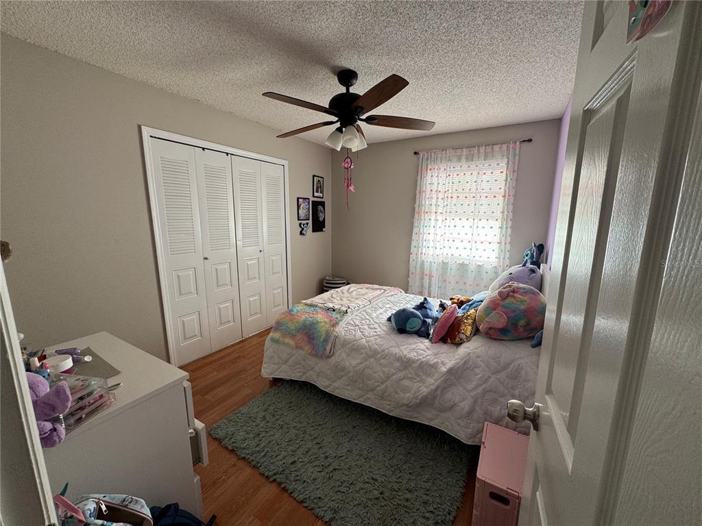 655 Magic Court, Unit 188 Altamonte Springs, FL 32714 - Photo 22 of 33 a bedroom with a bed and wooden floor