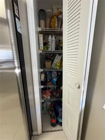 a bedroom with a bed and a mirror on dresser