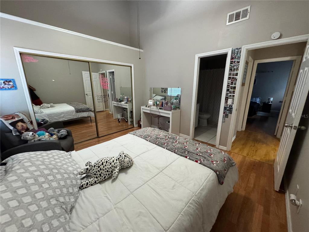 655 Magic Court, Unit 188 Altamonte Springs, FL 32714 - Photo 24 of 33 a bedroom with a bed and a mirror on dresser