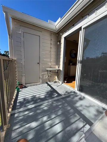 a view of a dining room with furniture a chandelier and wooden floor