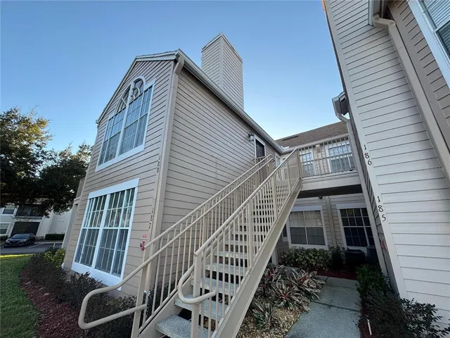 a view of a house with backyard and deck