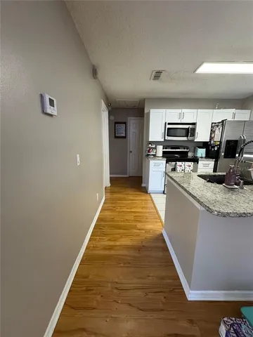 a large kitchen with kitchen island a stove top oven a sink and dishwasher