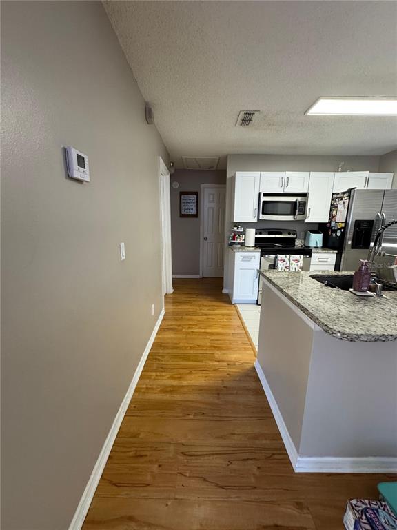 655 Magic Court, Unit 188 Altamonte Springs, FL 32714 - Photo 8 of 33 a large kitchen with kitchen island a stove top oven a sink and dishwasher