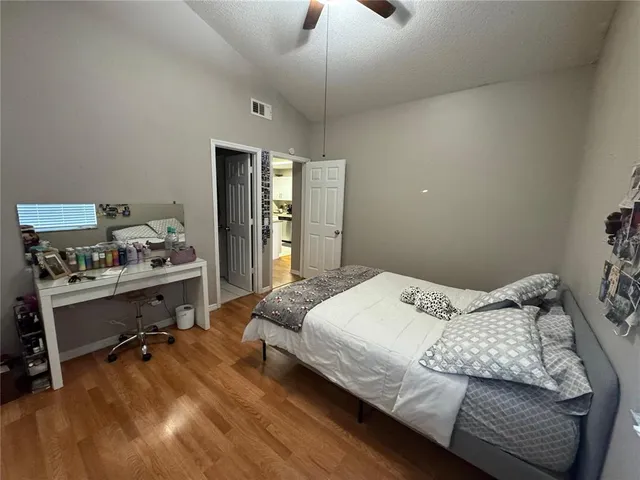 a bedroom with a bed and a desk