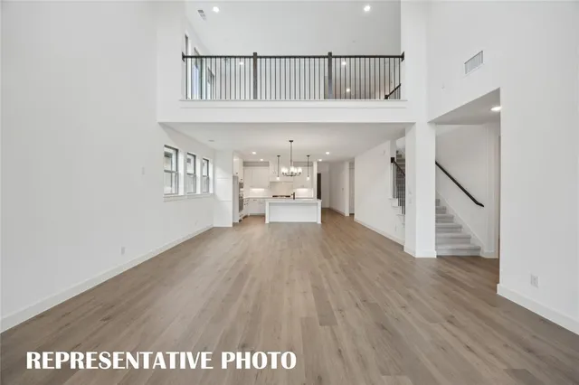 a view of kitchen with kitchen island wooden floor and center island