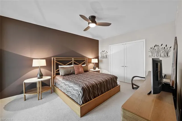 a bedroom with a bed and ceiling fan