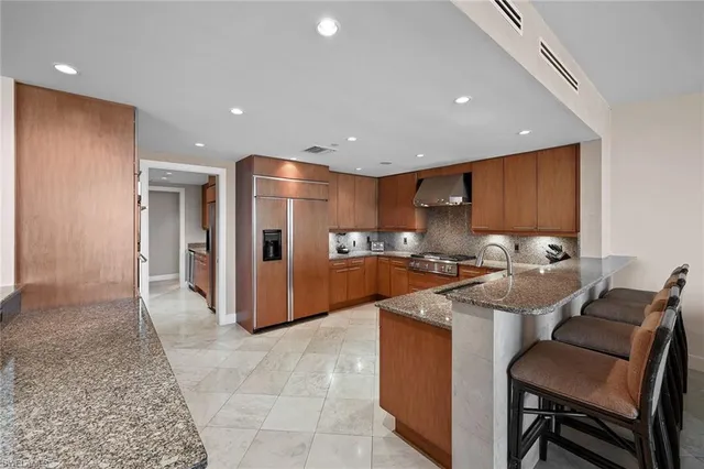 a kitchen with stainless steel appliances granite countertop a sink and cabinets