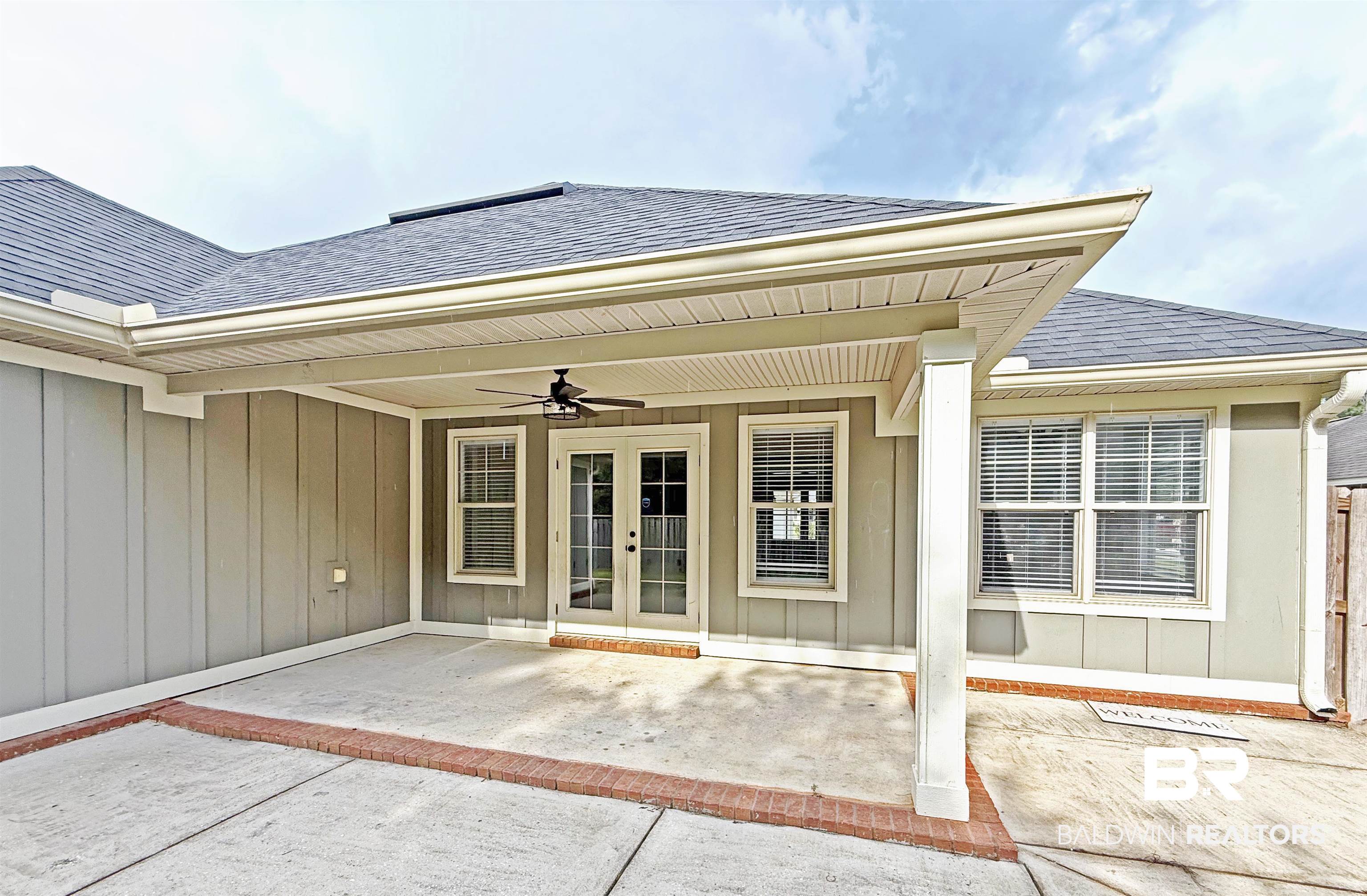 22023 Garland Loop Silverhill, AL 36576 - Photo 31 of 33 Entrance to property with roof with shingles, a ceiling fan, french doors, a patio area, and board and batten siding